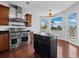 Bright kitchen with stainless steel range and hood, an island, and sunlit windows framing tropical views at 9315 9Th Nw Ave, Bradenton, FL 34209