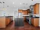 Spacious kitchen with stainless steel appliances, black countertops, wooden cabinets, and center island at 9315 9Th Nw Ave, Bradenton, FL 34209