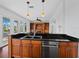 Gourmet kitchen featuring a breakfast bar, stainless steel appliances, dark countertops, and natural wood cabinetry at 9315 9Th Nw Ave, Bradenton, FL 34209