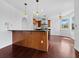 Kitchen view featuring wooden cabinets, stainless steel appliances, an island with bar seating, and modern pendant lights at 9315 9Th Nw Ave, Bradenton, FL 34209