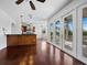 Open-concept living room with hardwood floors, kitchen view, and balcony access through white French doors at 9315 9Th Nw Ave, Bradenton, FL 34209