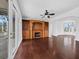 Bright living room with hardwood floors, fireplace, built-in shelving, and access to an outdoor balcony at 9315 9Th Nw Ave, Bradenton, FL 34209