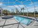 Enclosed swimming pool with hot tub surrounded by landscaping and white framework at 9315 9Th Nw Ave, Bradenton, FL 34209