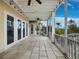 Spacious screened porch featuring tiled flooring, ceiling fans, and multiple entry points to the home at 9315 9Th Nw Ave, Bradenton, FL 34209