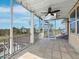 Charming screened porch with a spiral staircase, ceiling fan, and views of the surrounding landscape at 9315 9Th Nw Ave, Bradenton, FL 34209