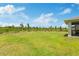 Expansive backyard featuring a lush lawn and beautiful blue skies, perfect for outdoor enjoyment at 9601 Calumet Blvd, Port Charlotte, FL 33981