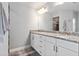 Bathroom with double granite vanity, white cabinets, and modern fixtures providing ample space and a clean aesthetic at 9601 Calumet Blvd, Port Charlotte, FL 33981
