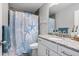 Bright bathroom with starfish-themed shower curtain, single granite vanity, and bright accents for a coastal vibe at 9601 Calumet Blvd, Port Charlotte, FL 33981