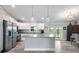 Open-concept kitchen featuring stainless steel appliances, granite countertops, and white cabinets at 9601 Calumet Blvd, Port Charlotte, FL 33981