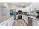 Open kitchen with granite countertops, stainless steel appliances, and shaker cabinets at 9601 Calumet Blvd, Port Charlotte, FL 33981