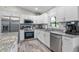 Beautiful kitchen featuring granite countertops, stainless steel appliances, and shaker cabinets at 9601 Calumet Blvd, Port Charlotte, FL 33981