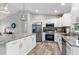 Bright kitchen featuring stainless steel appliances, granite countertops, and white cabinets at 9601 Calumet Blvd, Port Charlotte, FL 33981