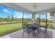 This screened lanai offers an inviting space to enjoy the outdoors with black metal table and seating with great views at 9601 Calumet Blvd, Port Charlotte, FL 33981