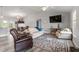 Bright living room with comfortable seating, neutral walls, wood-look tile flooring, and an airy feel at 9601 Calumet Blvd, Port Charlotte, FL 33981