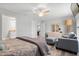 This main bedroom features a ceiling fan, dresser, chair, and ensuite bathroom for added comfort and convenience at 9601 Calumet Blvd, Port Charlotte, FL 33981