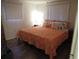 Comfortable bedroom featuring wood look floors, and a full sized bed with decorative pillows, and a bright beachy theme at 9835 El Camino Real Ave, Port Richey, FL 34668