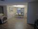 Inviting dining area featuring wood floors, modern lighting, and access to outdoor patio, blending indoor comfort with outdoor views at 9835 El Camino Real Ave, Port Richey, FL 34668