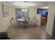 Bright dining room with wood floors, modern lighting, and sliding glass doors to the outdoor patio at 9835 El Camino Real Ave, Port Richey, FL 34668