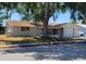 Charming single story home with covered porch and mature shade trees at 9835 El Camino Real Ave, Port Richey, FL 34668