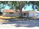 Charming single story home with covered porch and mature shade trees at 9835 El Camino Real Ave, Port Richey, FL 34668
