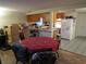 Open-concept kitchen and dining area with warm cabinetry, functional appliances, and tiled flooring at 9835 El Camino Real Ave, Port Richey, FL 34668