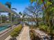 Lush backyard with pool, path and water views at 1014 Contento St, Sarasota, FL 34242