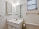 Standard bathroom with a large mirror, window, and a light-colored countertop at 1014 Contento St, Sarasota, FL 34242