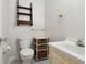 Well lit bathroom with a vintage vanity, toilet, and vertically striped wallpaper at 1014 Contento St, Sarasota, FL 34242