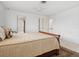 Bright bedroom with ceiling fan, doors to hall and closet, and plush bedding at 1014 Contento St, Sarasota, FL 34242