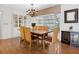 Elegant dining room featuring a wooden table, chandelier lighting, a bay window, and built-in cabinet at 1014 Contento St, Sarasota, FL 34242