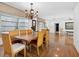 Spacious dining room featuring a wooden table and chandelier, with natural light and hardwood flooring at 1014 Contento St, Sarasota, FL 34242