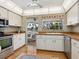 Bright kitchen with wood floors and stainless steel appliances, adjacent to the pool area at 1014 Contento St, Sarasota, FL 34242
