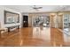 Open living room with hardwood floors, a wall of mirrors, and sliding glass doors leading to an outdoor pool area at 1014 Contento St, Sarasota, FL 34242