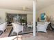 Inviting covered patio featuring wicker seating and stylish brick flooring for relaxing and entertaining at 1014 Contento St, Sarasota, FL 34242
