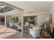 Relaxing covered patio features wicker seating, ceiling fans, and brick flooring at 1014 Contento St, Sarasota, FL 34242
