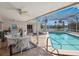 A covered patio with pool, outdoor seating, and beautiful lake views at 1014 Contento St, Sarasota, FL 34242