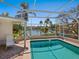 Screened-in pool with views of the water at 1014 Contento St, Sarasota, FL 34242