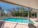 The pool is enclosed with tropical views, and a screened in enclosure at 1014 Contento St, Sarasota, FL 34242