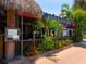 Charming restaurant exterior with a thatched roof, nautical accents, and vibrant flowers, creating a welcoming seaside atmosphere at 1014 Contento St, Sarasota, FL 34242