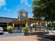 Inviting restaurant exterior with a pergola, outdoor seating, and lush greenery, perfect for enjoying a meal in a relaxed setting at 1014 Contento St, Sarasota, FL 34242
