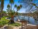 Waterfront backyard featuring tropical landscaping, dock and boat lift at 1014 Contento St, Sarasota, FL 34242