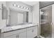 Bathroom with double sinks, granite countertops, and walk-in shower at 1033 Grantham Dr, Sarasota, FL 34234