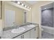 Bathroom with double sinks, granite countertops, and a shower/tub combo at 1033 Grantham Dr, Sarasota, FL 34234