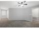 Bedroom featuring neutral carpet, ceiling fan, and access to other rooms at 1033 Grantham Dr, Sarasota, FL 34234