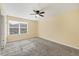 Bedroom with neutral carpet, ceiling fan, and natural light from a window at 1033 Grantham Dr, Sarasota, FL 34234