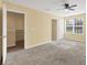 Bedroom features neutral carpet, a ceiling fan, and access to other rooms at 1033 Grantham Dr, Sarasota, FL 34234