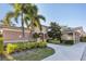 View of community clubhouse with sign, landscaping, and palm trees at 1033 Grantham Dr, Sarasota, FL 34234