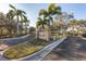 Well manicured community entrance with landscaped median and stone monument at 1033 Grantham Dr, Sarasota, FL 34234