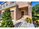 The door and garage to a tan townhouse, with plants on either side at 1033 Grantham Dr, Sarasota, FL 34234