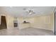 A modern living room flows into the open-concept kitchen featuring sleek tile floors, neutral colors, and great natural light at 1033 Grantham Dr, Sarasota, FL 34234
